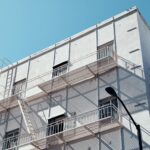 Modern building exterior with fire escapes, located in San Francisco under a clear blue sky.