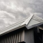 gray and white wooden house under white clouds